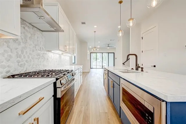 a kitchen with a sink stove and cabinets