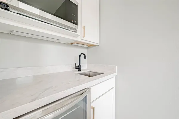 a kitchen with a sink and cabinets