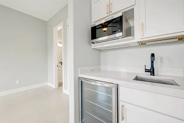 a kitchen with stainless steel appliances granite countertop a sink and a microwave