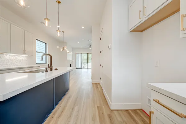 a view of a kitchen with a sink and wooden floor