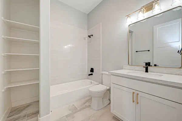 a bathroom with a sink a toilet and a bathtub
