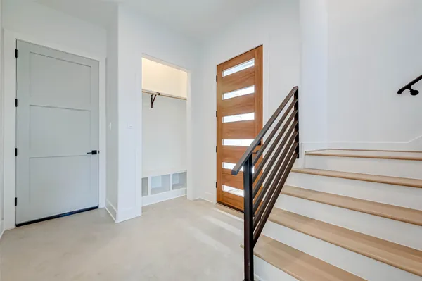 a view of entryway and hall with wooden floor