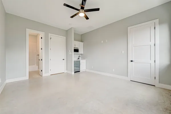 an empty room with closet and windows
