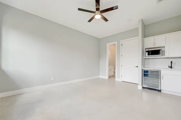 a view of a kitchen with a sink and a refrigerator