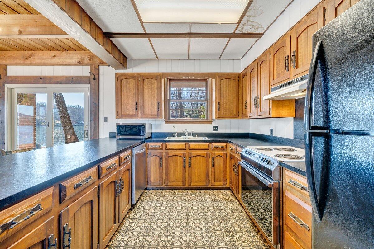 188 Hardy Court Penhook, VA 24137 - Photo 22 of 114 a kitchen with stainless steel appliances granite countertop a sink stove and cabinets