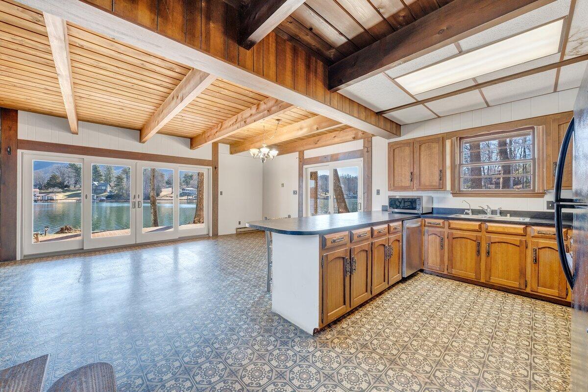 188 Hardy Court Penhook, VA 24137 - Photo 23 of 114 a large kitchen with stainless steel appliances wooden cabinets a sink and a large window