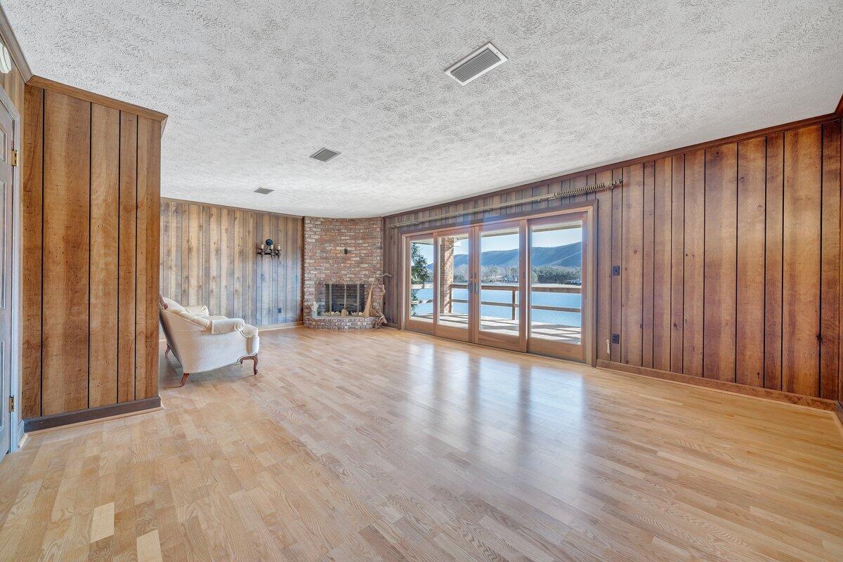 188 Hardy Court Penhook, VA 24137 - Photo 33 of 114 a view of an empty room with glass door and wooden floor