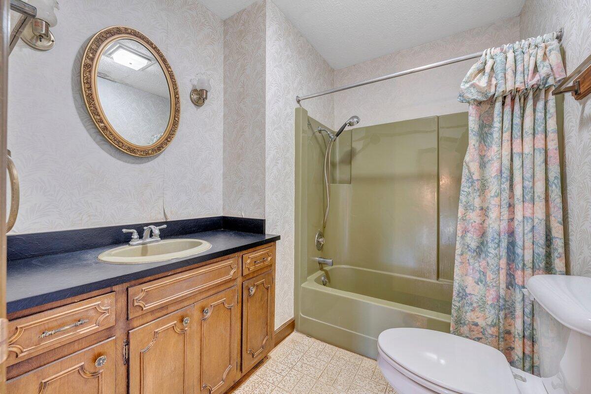 188 Hardy Court Penhook, VA 24137 - Photo 45 of 114 a bathroom with a granite countertop sink toilet a mirror and shower