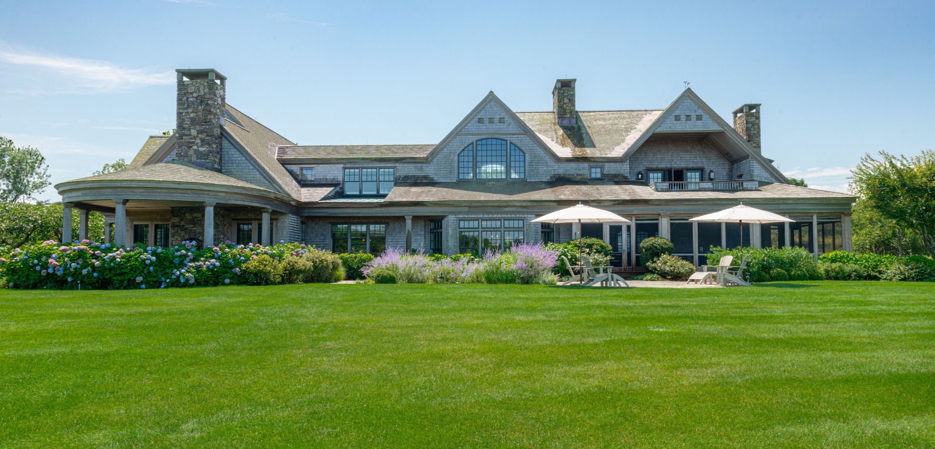 183 Polpis Road Nantucket, MA 02554 - Photo 5 of 62 a front view of a house with a garden