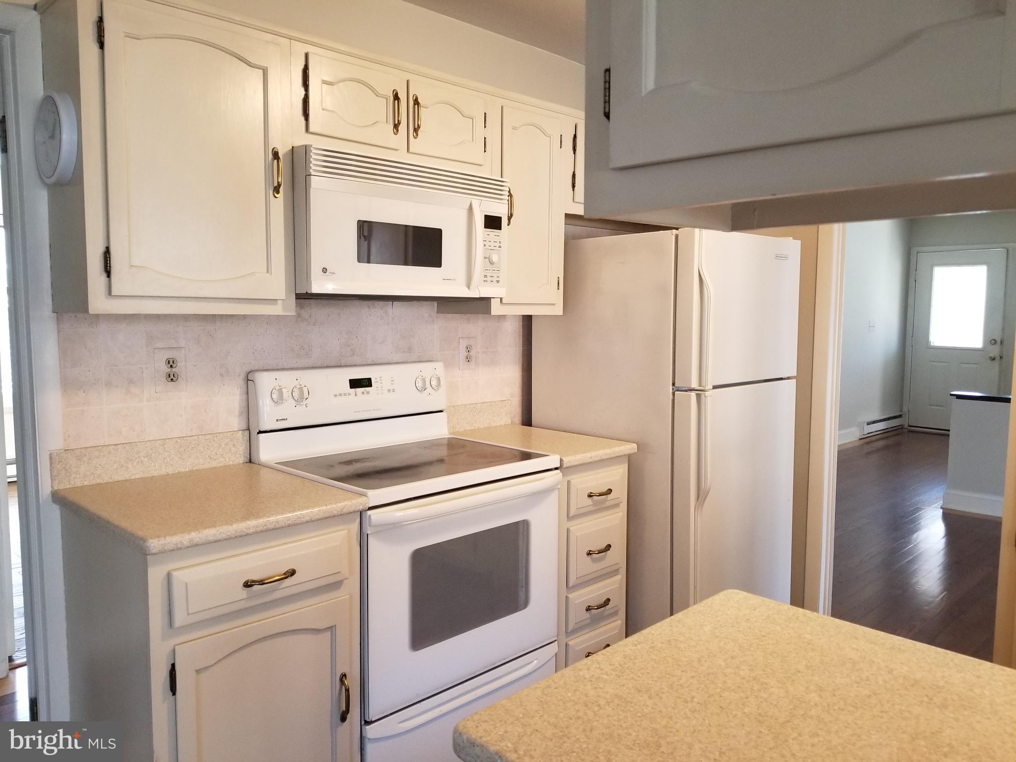 26 Dunstable Road Southampton, NJ 08088 - Photo 12 of 31 a kitchen with stainless steel appliances white cabinets and white appliances