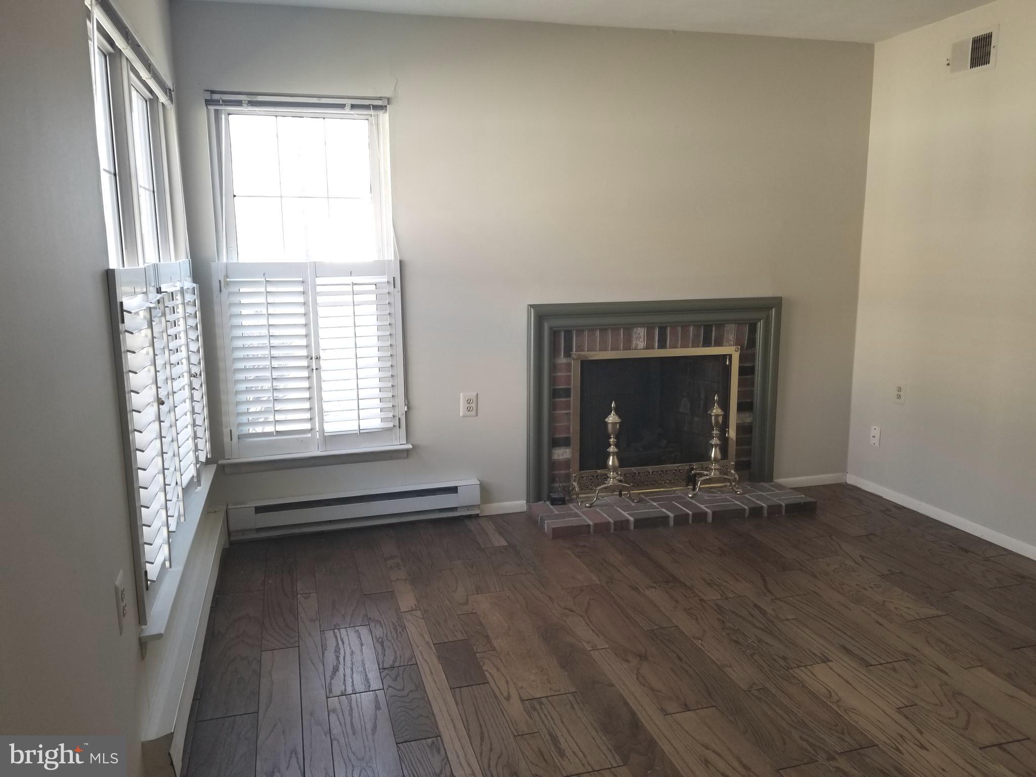 26 Dunstable Road Southampton, NJ 08088 - Photo 15 of 31 a view of an empty room with exposed radiator and fireplace