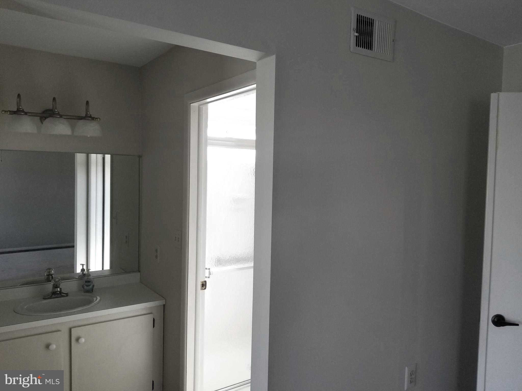 26 Dunstable Road Southampton, NJ 08088 - Photo 18 of 31 a room with a sink and a mirror