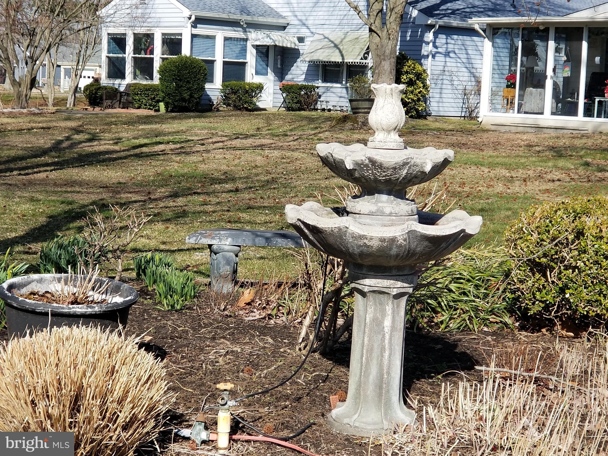 26 Dunstable Road Southampton, NJ 08088 - Photo 28 of 31 a front view of a house with a yard and fountain in front of it