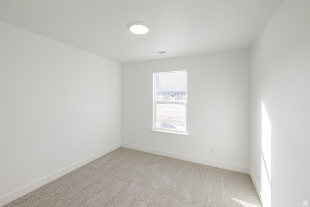 4775 Olive Avenue, Unit 412 Mapleton, UT 84664 - Photo 14 of 19 Spare room featuring light carpet and baseboards