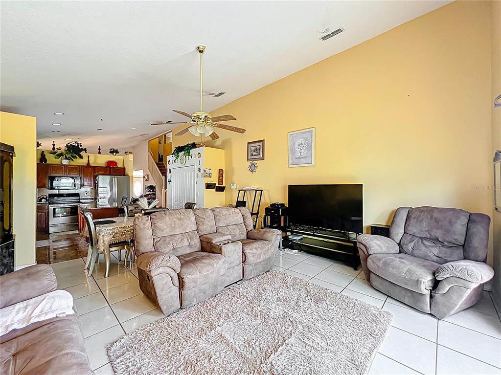 7939 Riffle Lane Orlando, FL 32818 - Photo 16 of 52 a living room with furniture and a flat screen tv