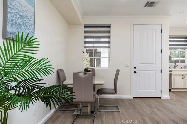 a view of a dining room with furniture and wooden floor