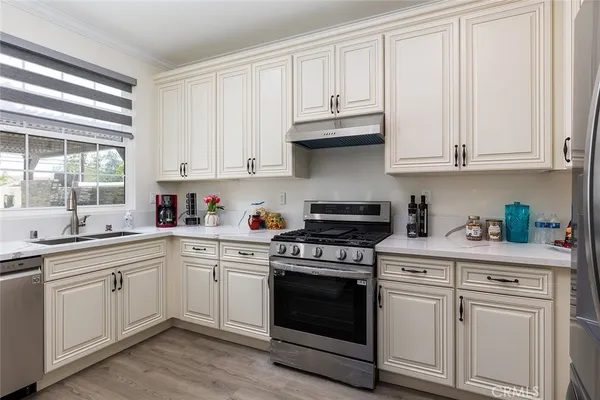 a kitchen with granite countertop white cabinets and white appliances