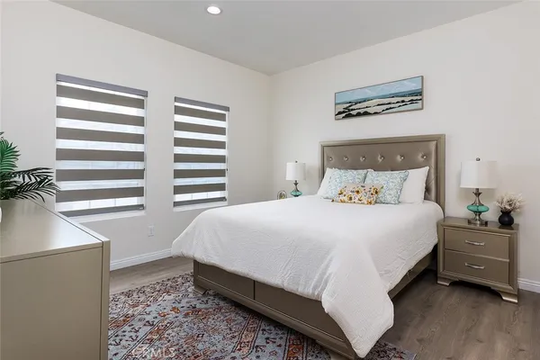 a bedroom with a bed and a night stand