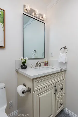a bathroom with a granite countertop sink a toilet and a mirror