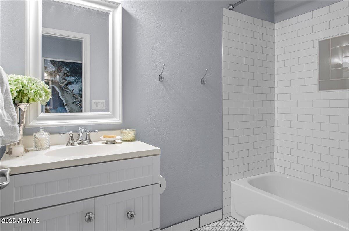 6520 East Osborn Road Scottsdale, AZ 85251 - Photo 13 of 21 a bathroom with a sink a toilet and shower