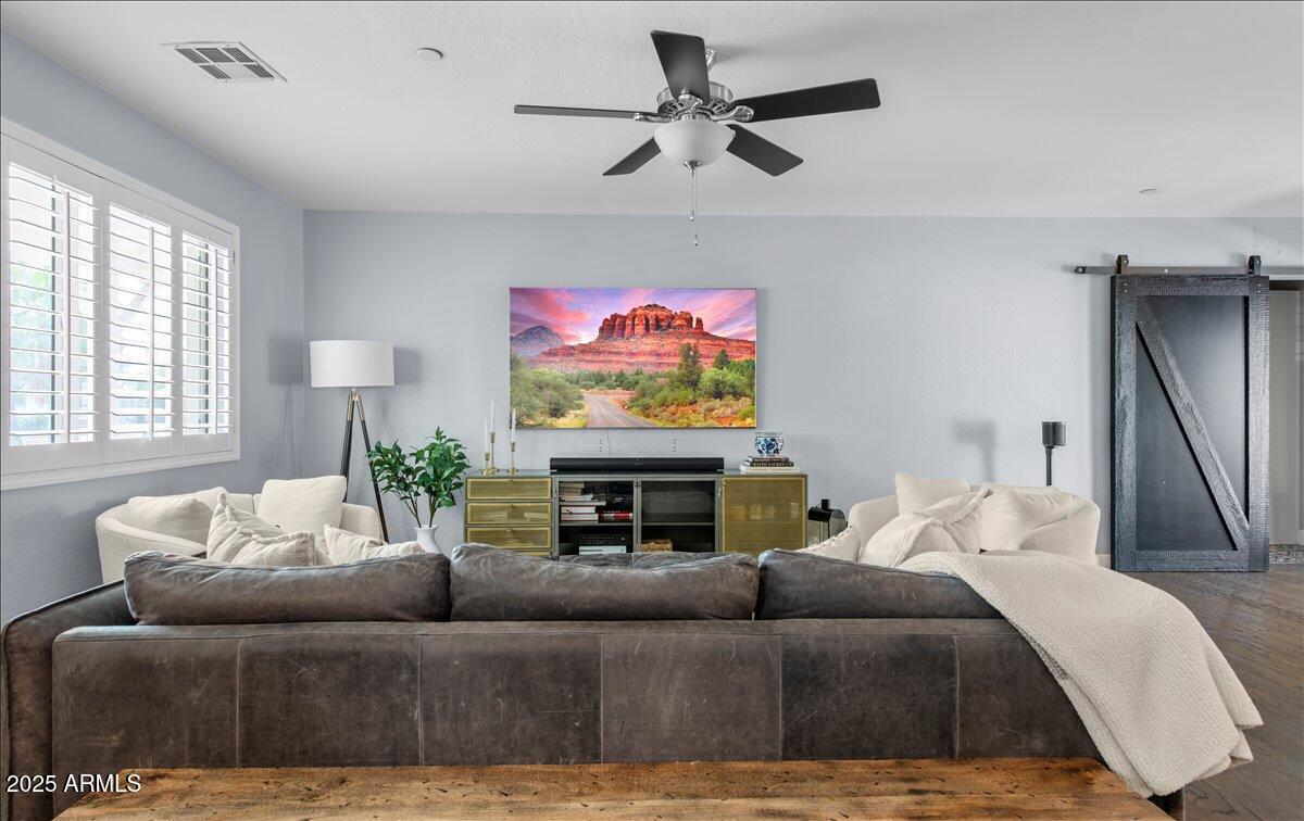 6520 East Osborn Road Scottsdale, AZ 85251 - Photo 3 of 21 a living room with furniture a window and a flat screen tv