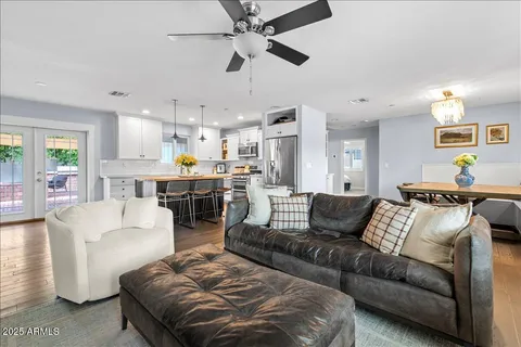 a living room with furniture and kitchen view