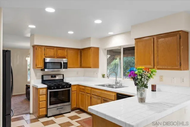 a kitchen with stainless steel appliances kitchen island granite countertop a sink and cabinets