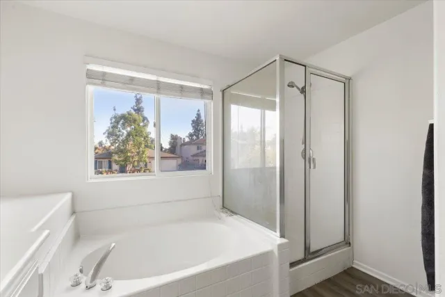 a white bath tub sitting next to a small bathroom