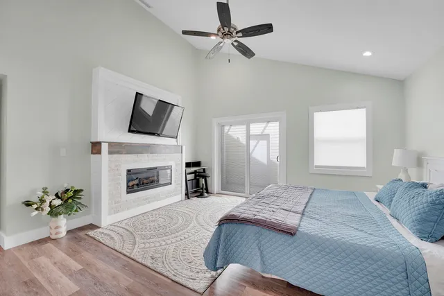 a spacious bedroom with a large bed and a fireplace