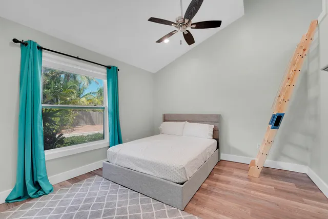 a bedroom with a large bed and a window