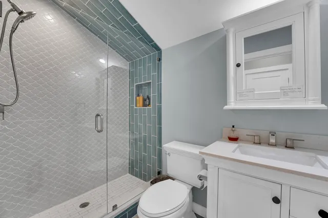 a bathroom with a sink toilet and shower