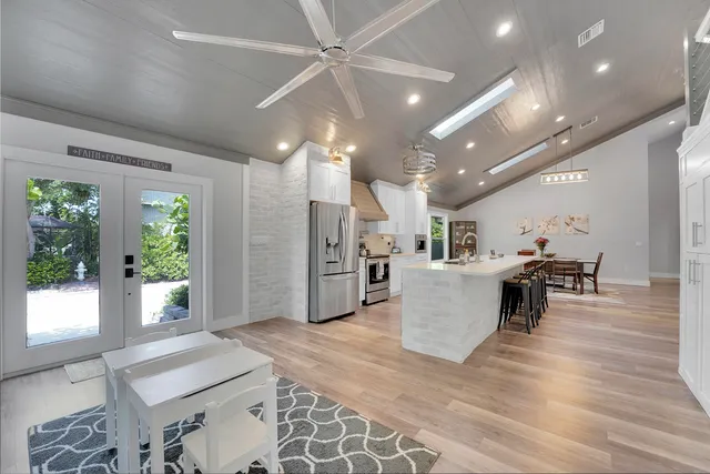 a dining room with furniture and wooden floor