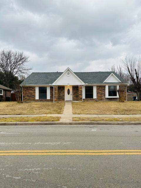205 Apollo Road Garland, TX 75040 - Photo 2 of 6 a front view of a house with a garden and trees