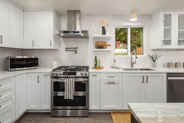 a kitchen with cabinets and stainless steel appliances