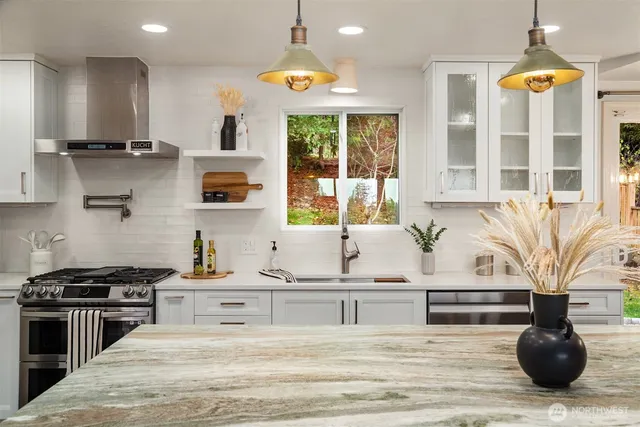 a kitchen with stainless steel appliances granite countertop a stove and a sink