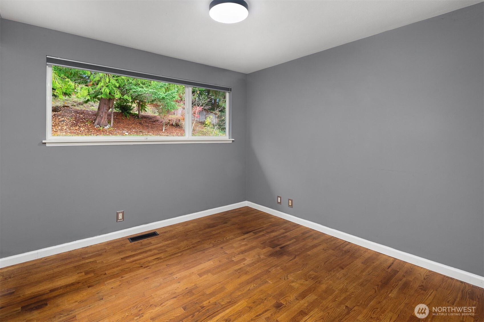 1221 Coronado Place Edmonds, WA 98020 - Photo 18 of 32 a view of empty room with wooden floor and fan