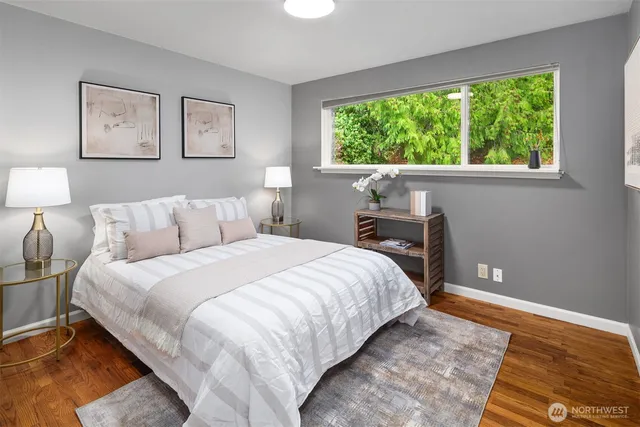 a bedroom with a bed and a large window