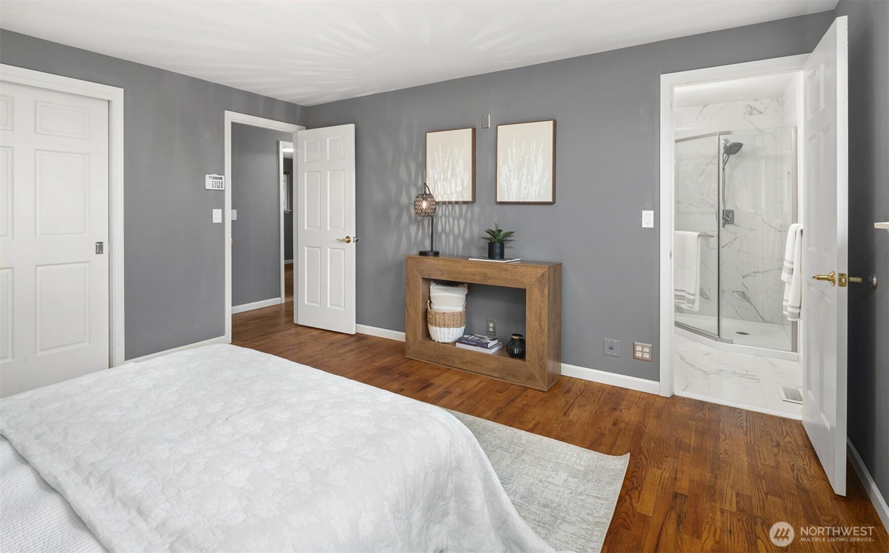 1221 Coronado Place Edmonds, WA 98020 - Photo 20 of 32 a spacious bedroom with a bed and a fireplace