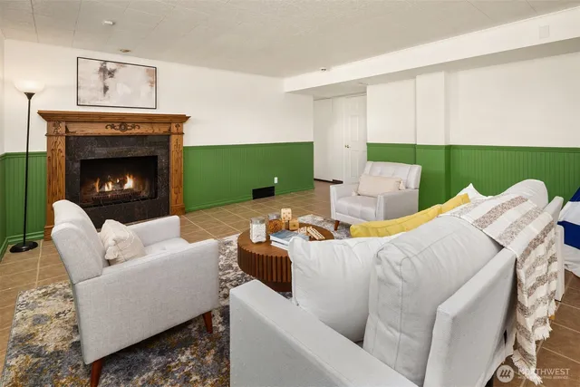 a living room with furniture a fireplace and a window