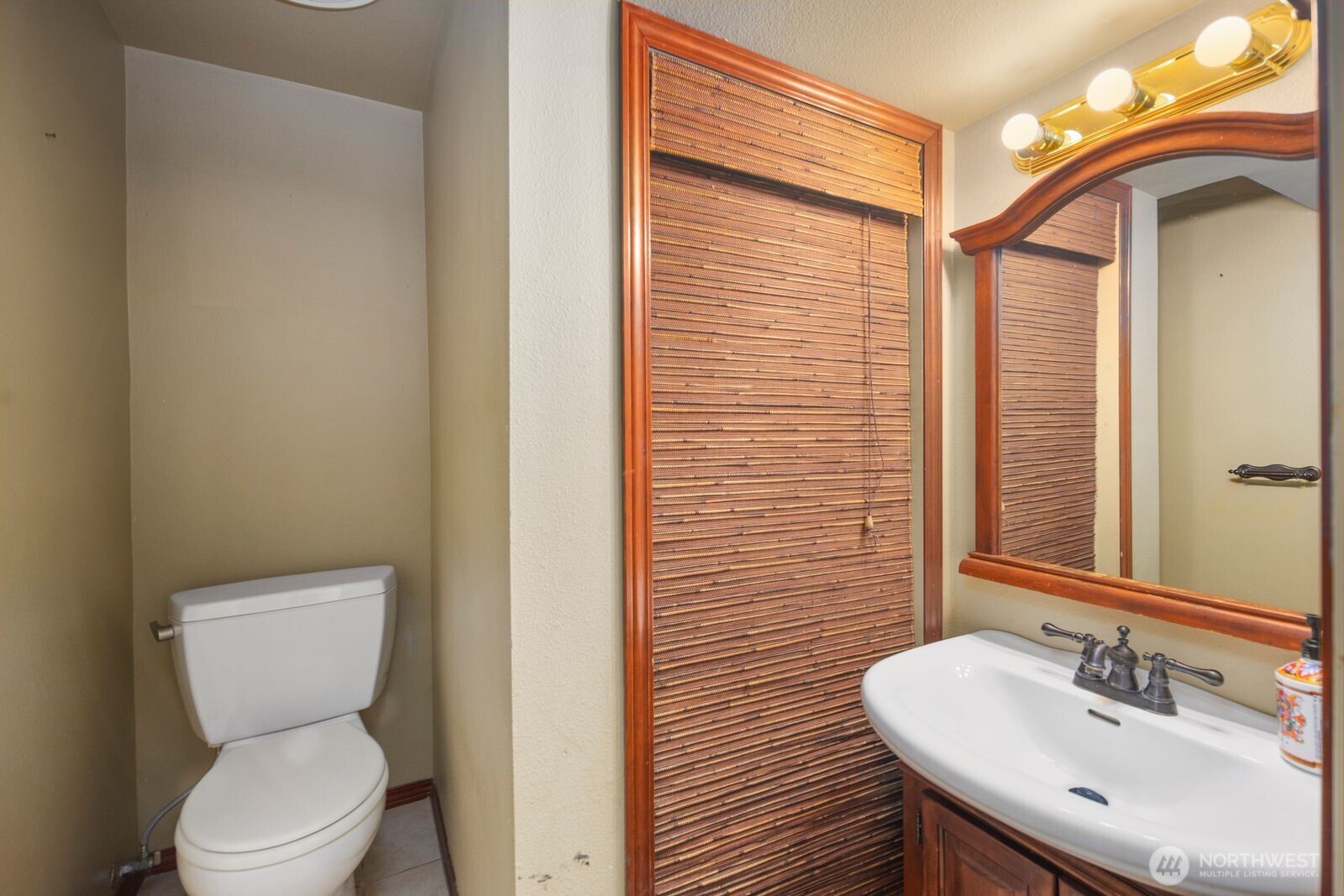 1221 Coronado Place Edmonds, WA 98020 - Photo 25 of 32 a bathroom with a toilet a sink and mirror