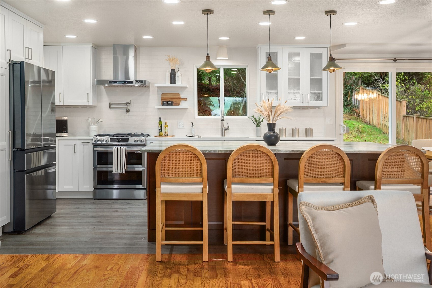 1221 Coronado Place Edmonds, WA 98020 - Photo 3 of 32 a kitchen with stainless steel appliances granite countertop a table chairs sink refrigerator and microwave