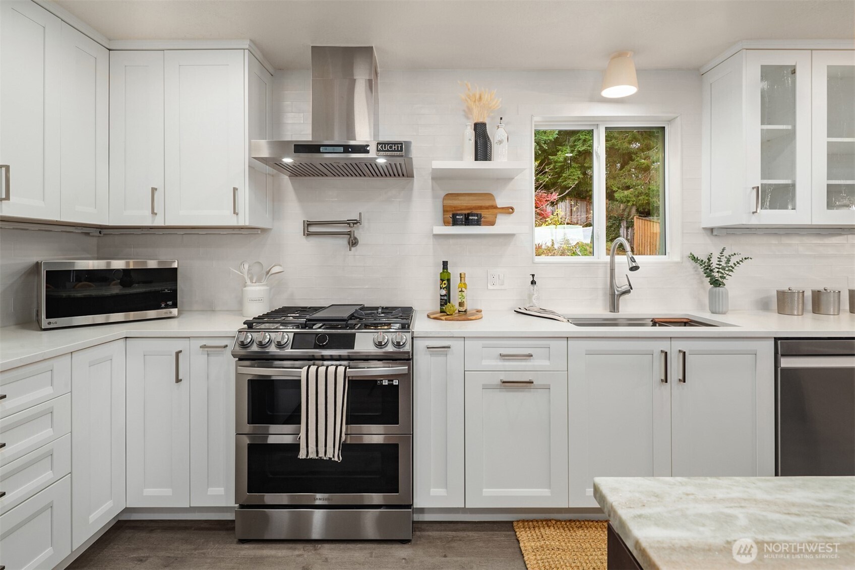 1221 Coronado Place Edmonds, WA 98020 - Photo 7 of 32 a kitchen with cabinets and stainless steel appliances