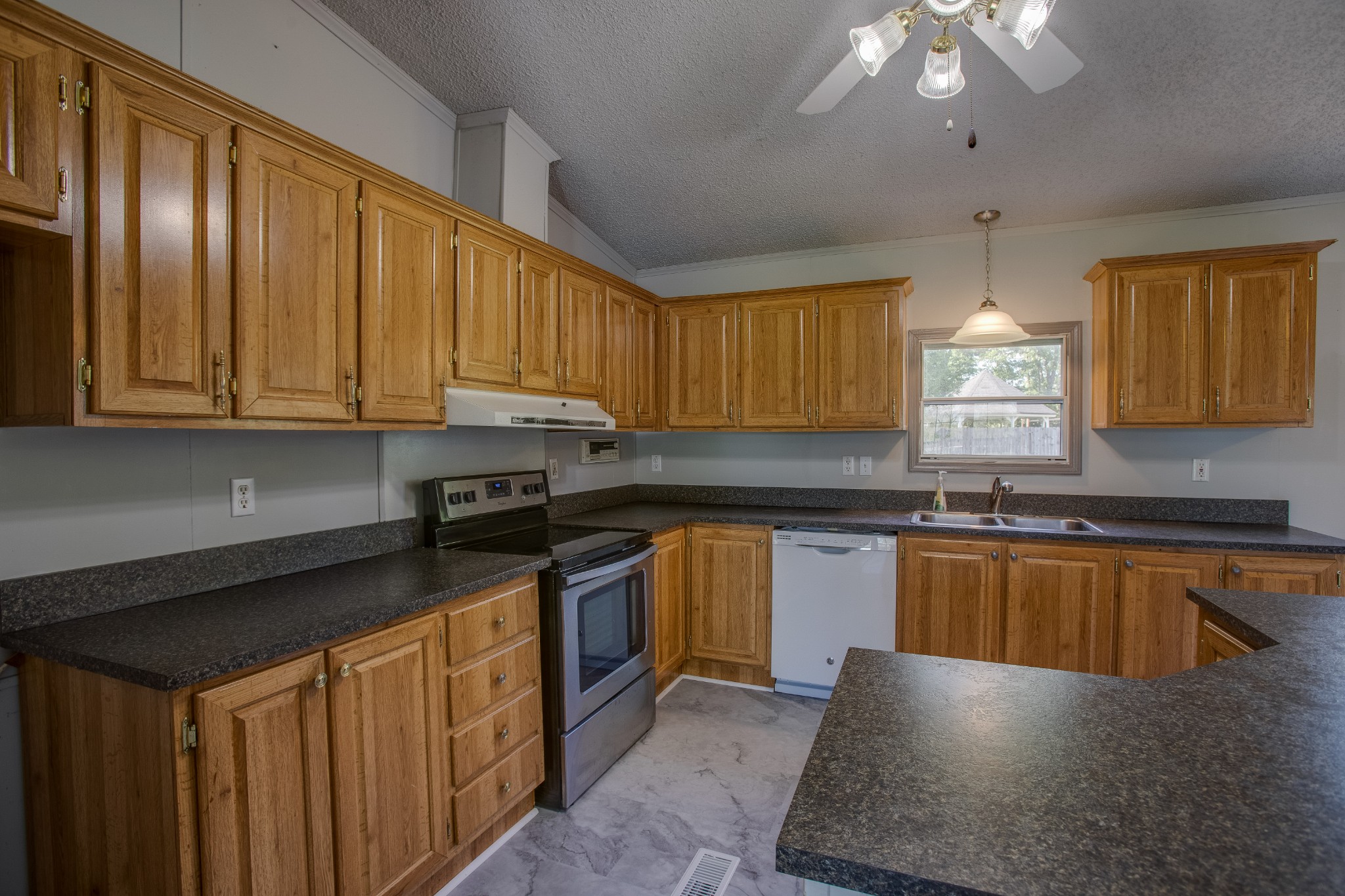4809 Ollie Chunn Road Spring Hill, TN 37174 - Photo 14 of 27 a kitchen with stainless steel appliances granite countertop a sink stove and cabinets