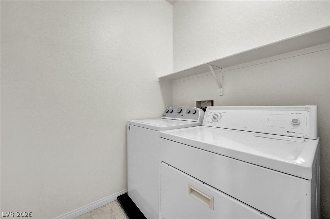 977 Sparkling Light Street Henderson, NV 89052 - Photo 49 of 75 This dedicated utility space features convenient laundry hookups and a practical storage shelf.