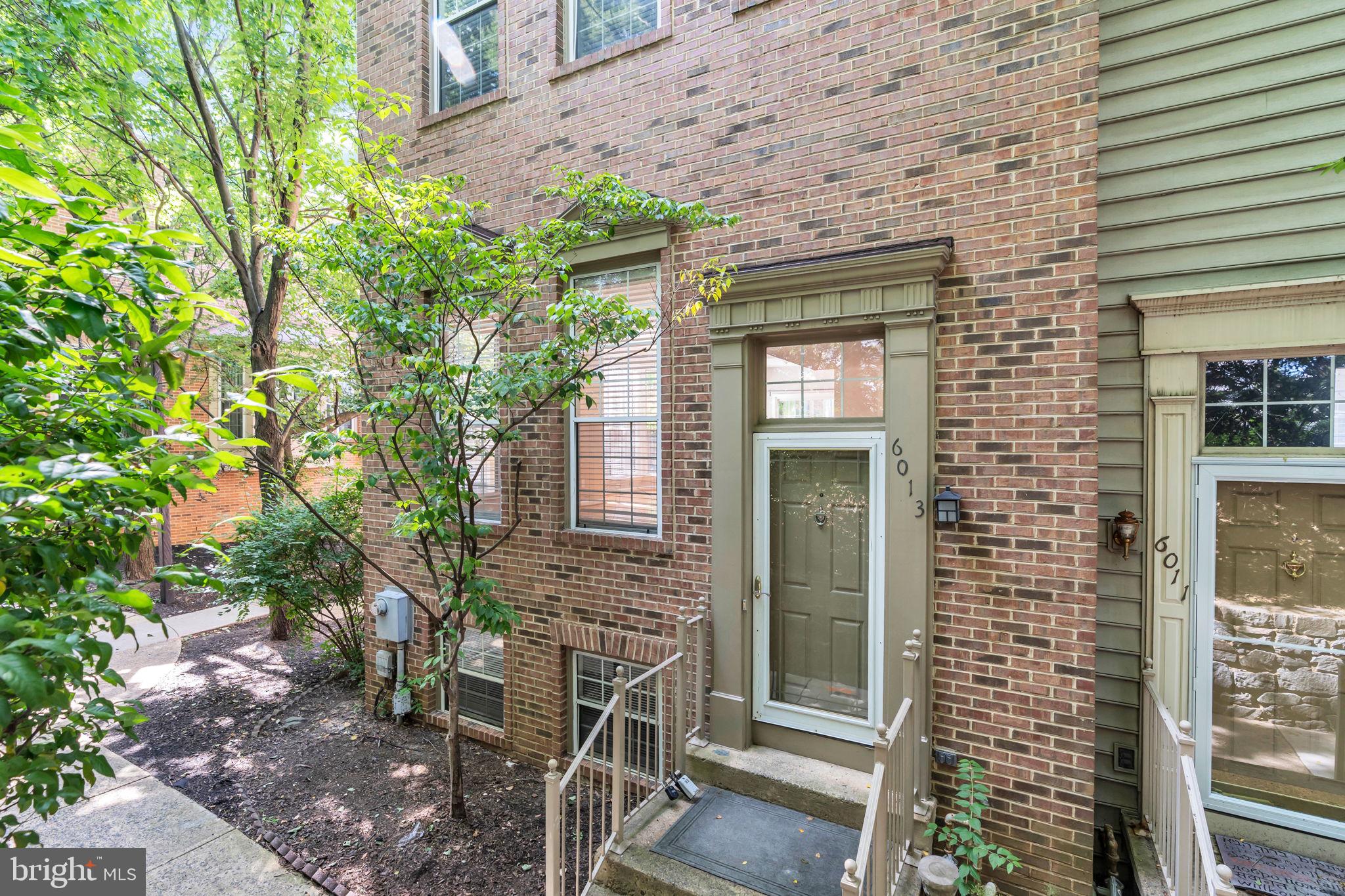 6013 Riddle Walk Alexandria, VA 22312 - Photo 2 of 31 a front view of a house with a tree
