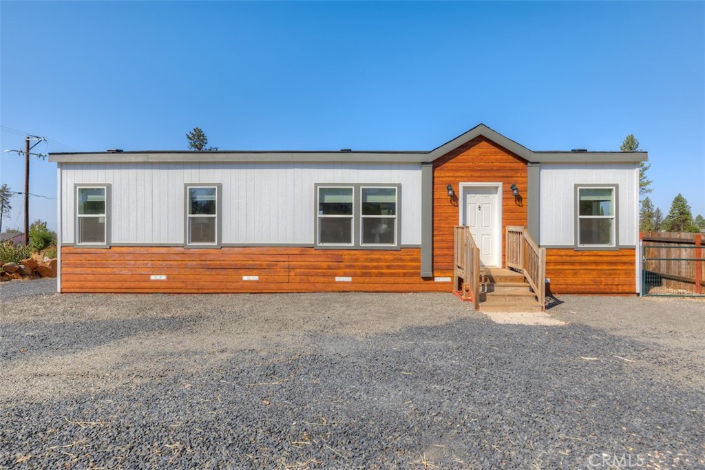 a view of backyard with a flat tv screen and a fireplace