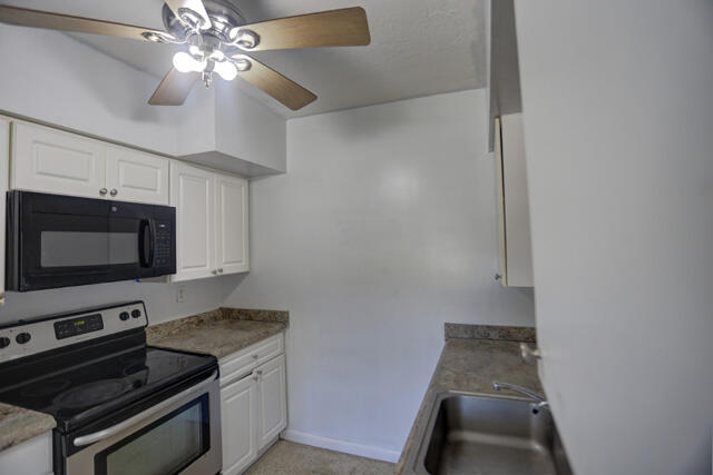 910 9th Street Lake Park, FL 33403 - Photo 21 of 34 Galley kitchen 910 9th St