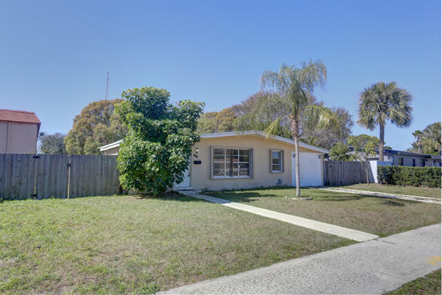 910 9th Street Lake Park, FL 33403 - Photo 33 of 34 Front SE view sidewalk 910 9th St Lake P