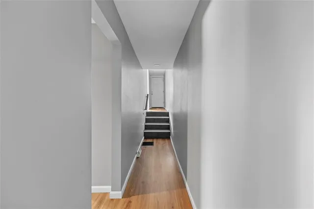 a view of a hallway with wooden staircase