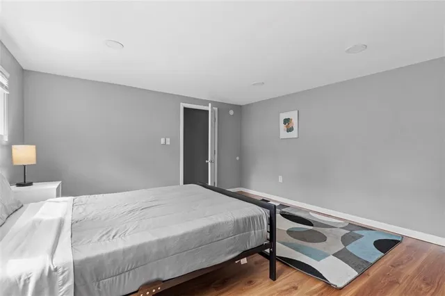 a bedroom with a bed and a night stand